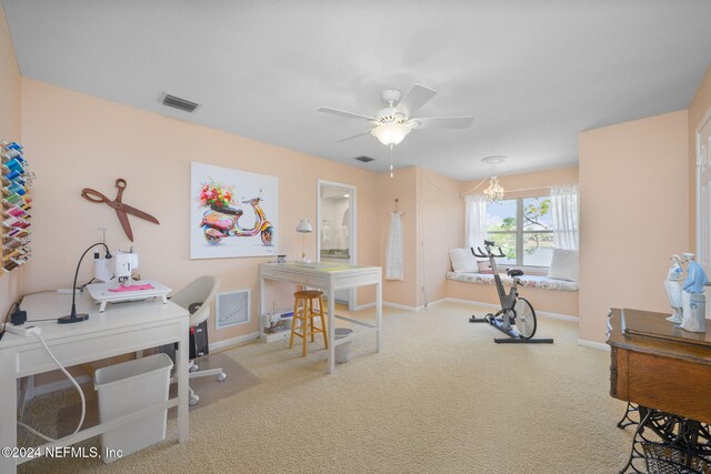 office space featuring carpet and ceiling fan with notable chandelier