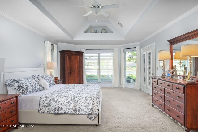 bedroom with crown molding, light carpet, a raised ceiling, vaulted ceiling, and ceiling fan