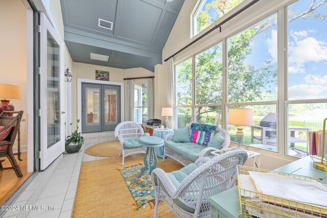 sunroom featuring a healthy amount of sunlight and lofted ceiling