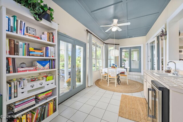 sunroom with french doors, sink, beverage cooler, and ceiling fan