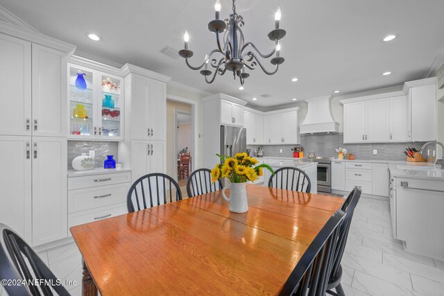 dining space featuring ornamental molding and an inviting chandelier