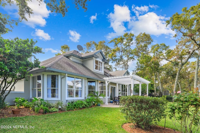 back of house featuring a pergola, a lawn, and a patio area