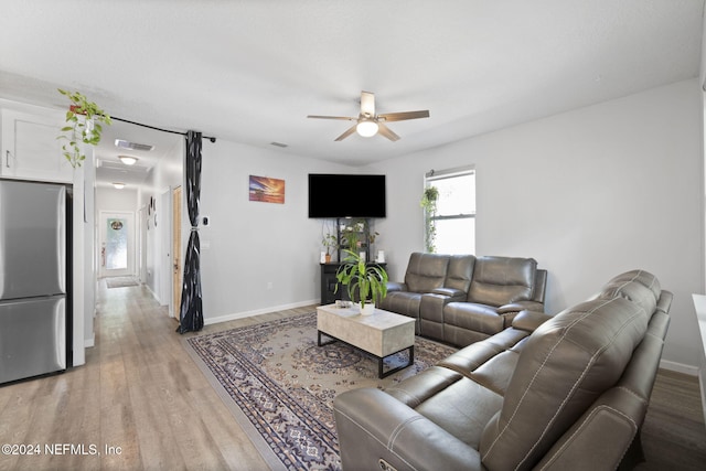 living room with ceiling fan and wood-type flooring