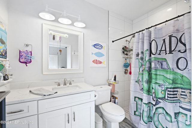 bathroom featuring vanity, toilet, and walk in shower