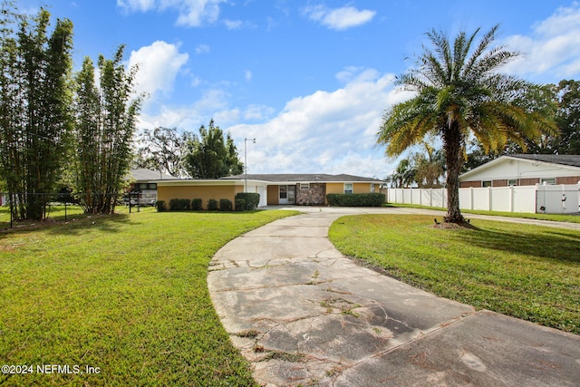 ranch-style home featuring a front yard