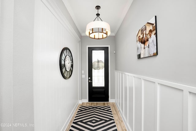 entryway featuring light hardwood / wood-style floors and crown molding