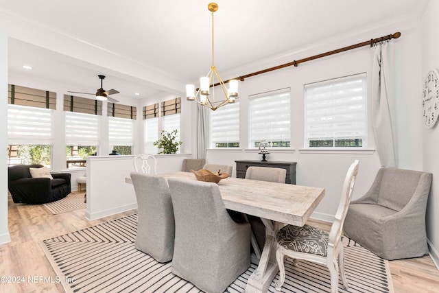 dining area featuring ceiling fan with notable chandelier, ornamental molding, and light hardwood / wood-style flooring