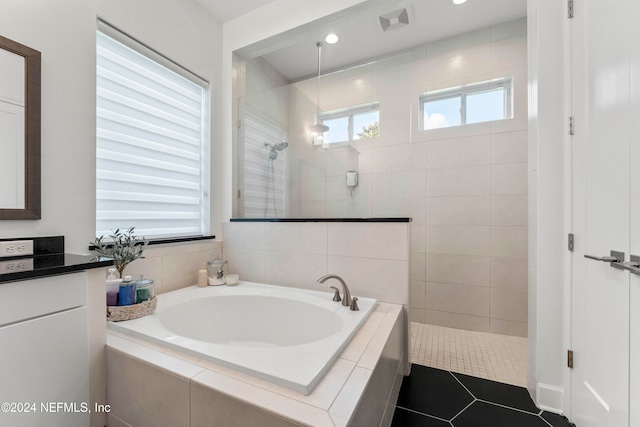 bathroom featuring vanity, tile patterned floors, and plus walk in shower