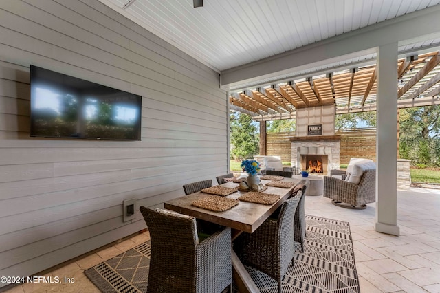 view of patio with an outdoor fireplace