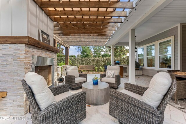 view of patio featuring an outdoor living space with a fireplace and a pergola