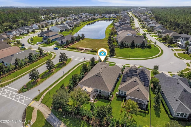 birds eye view of property with a water view