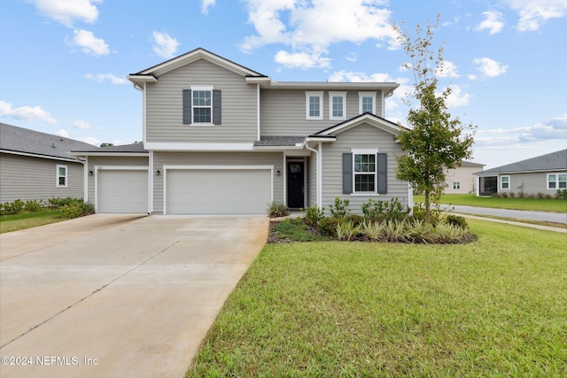 view of property featuring a front yard and a garage