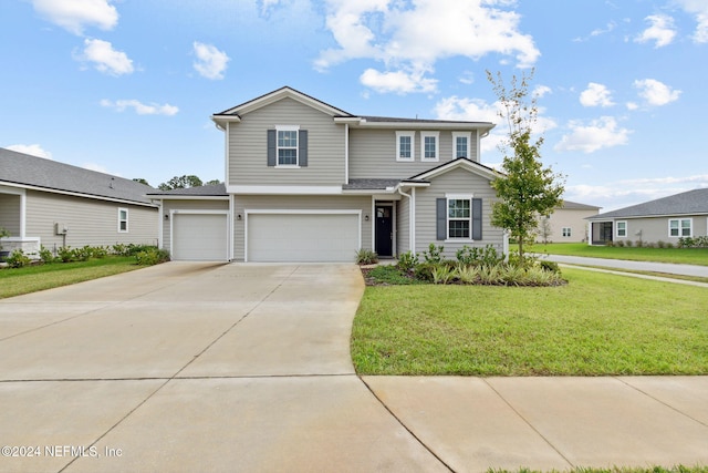 view of front property with a garage and a front yard