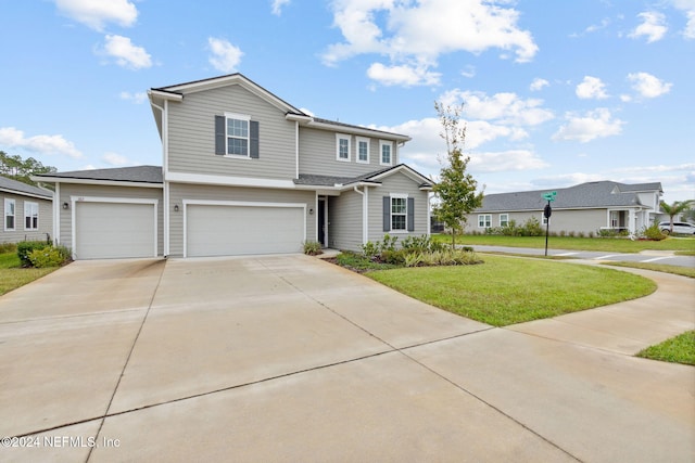 front facade featuring a front lawn and a garage