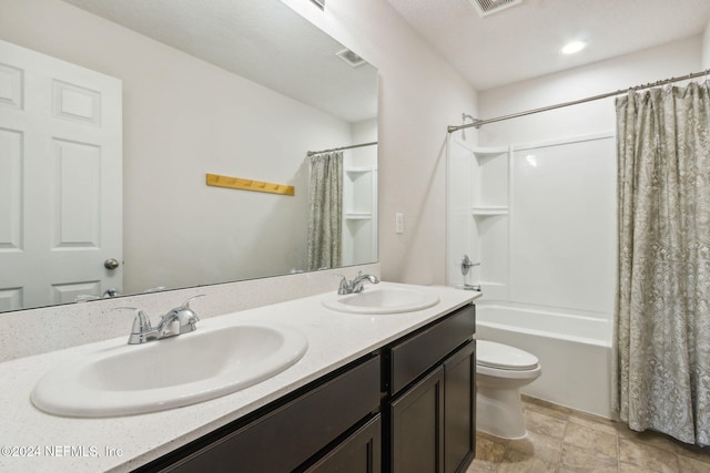 full bathroom featuring shower / bath combo, vanity, and toilet