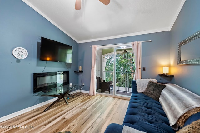 living room with lofted ceiling, ceiling fan, a textured ceiling, light hardwood / wood-style flooring, and crown molding