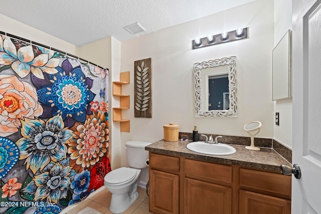 bathroom with curtained shower, a textured ceiling, toilet, tile patterned floors, and vanity