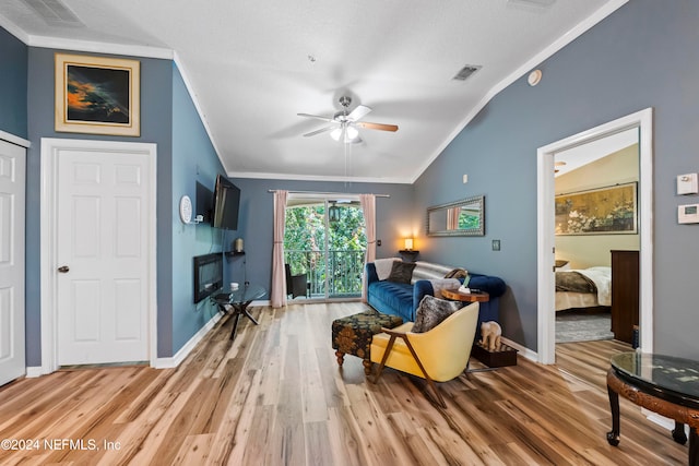 sitting room featuring ornamental molding, hardwood / wood-style floors, vaulted ceiling, a textured ceiling, and ceiling fan