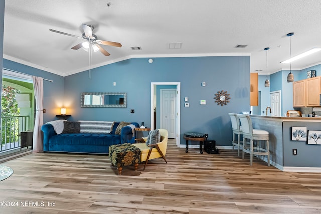 interior space featuring access to outside, ceiling fan, ornamental molding, and hardwood / wood-style floors