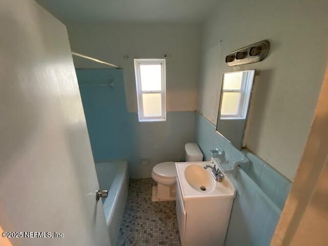 bathroom featuring vanity, shower / tub combination, toilet, and tile patterned floors