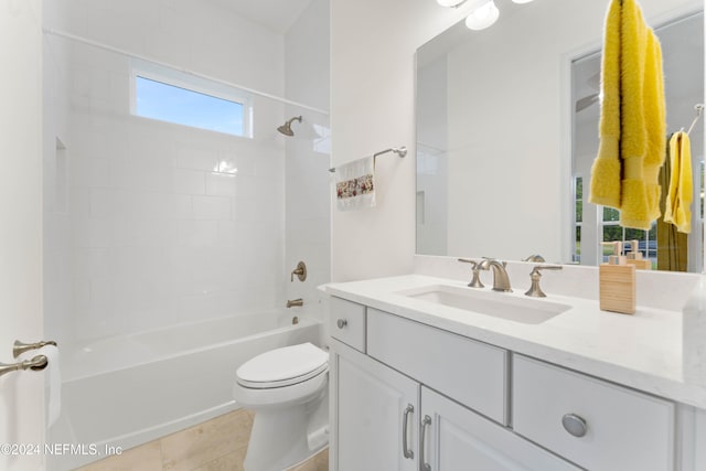 full bathroom with vanity, tiled shower / bath combo, toilet, and tile patterned flooring