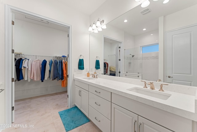 bathroom featuring tiled shower, vanity, and tile patterned floors