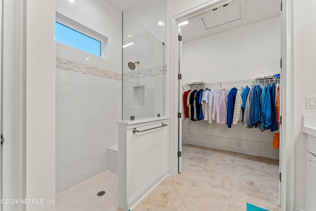 bathroom with vanity and tiled shower