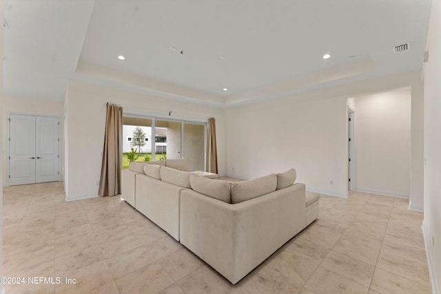 living room featuring a raised ceiling