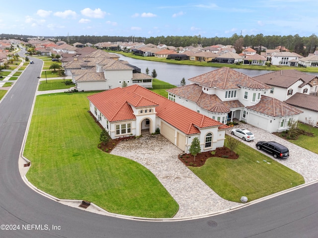 birds eye view of property with a water view