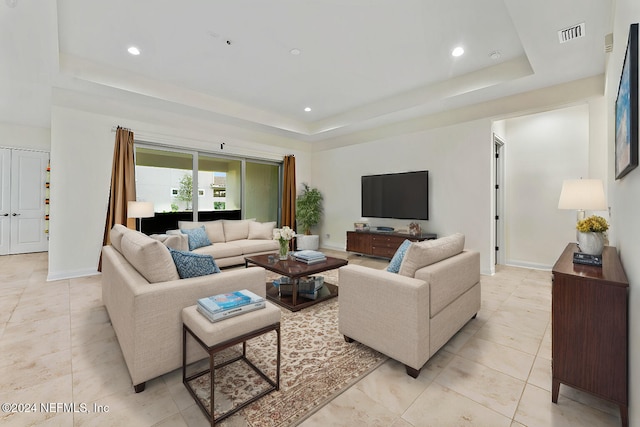 living room featuring a raised ceiling