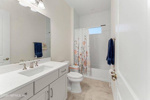 full bathroom with tile patterned flooring, shower / tub combo with curtain, vanity, and toilet