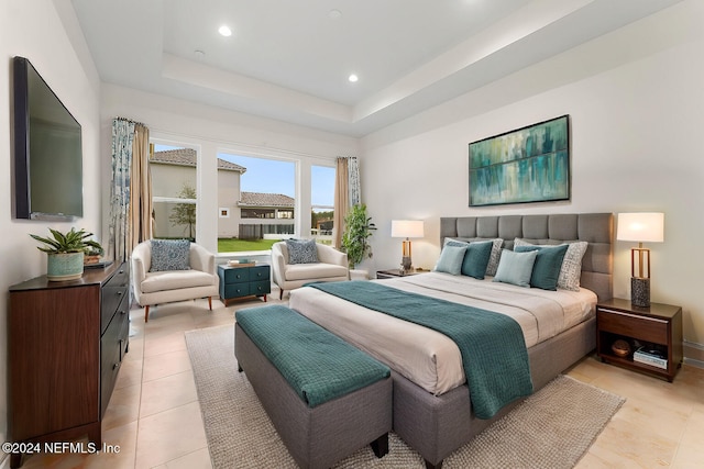 bedroom featuring a raised ceiling and light tile patterned floors