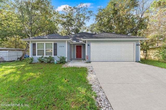 single story home featuring a garage and a front lawn