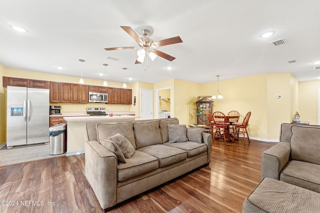 living room with ceiling fan and hardwood / wood-style floors