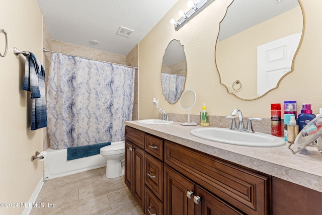 full bathroom featuring vanity, toilet, shower / bath combo with shower curtain, and a textured ceiling