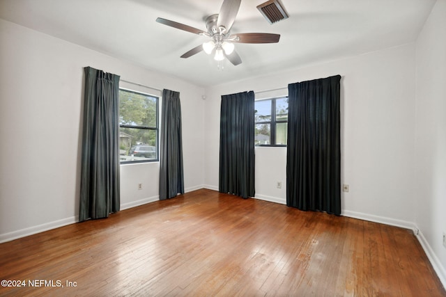 empty room featuring hardwood / wood-style floors and ceiling fan