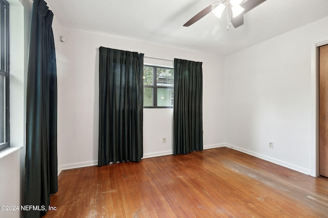 spare room featuring hardwood / wood-style flooring and ceiling fan