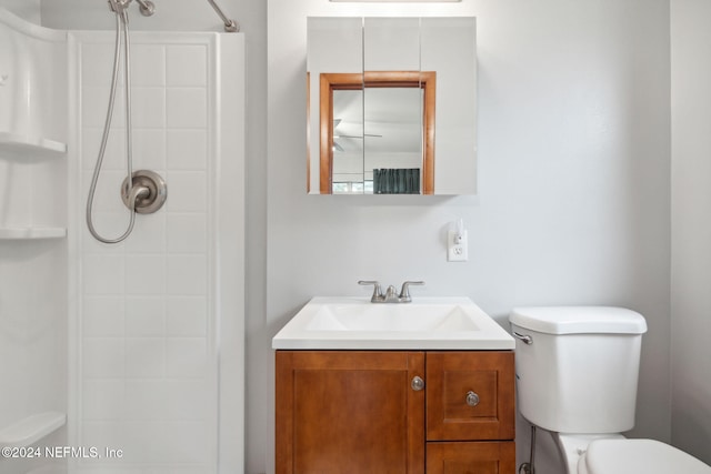 bathroom featuring vanity, toilet, and a shower