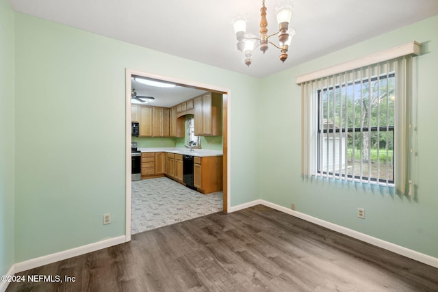 interior space with wood-type flooring, sink, and an inviting chandelier