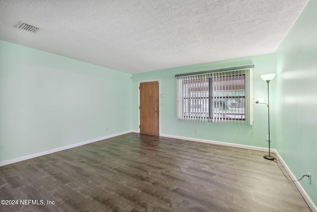 spare room with hardwood / wood-style flooring and a textured ceiling