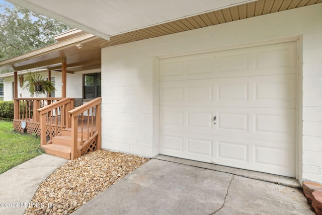 doorway to property featuring a garage and covered porch