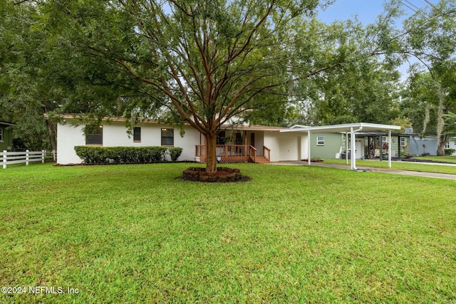 single story home featuring a front lawn and a carport