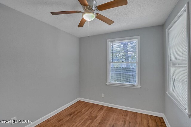 2112 Prospect St, Jacksonville, FL 32254 - unfurnished room featuring ceiling fan, a textured ceiling, baseboards, and wood finished floors