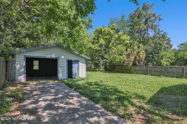 view of yard featuring an outbuilding and a garage