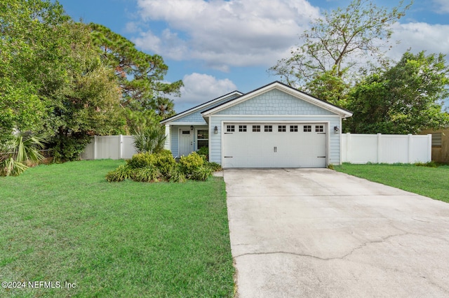 view of front facade featuring a front yard and a garage