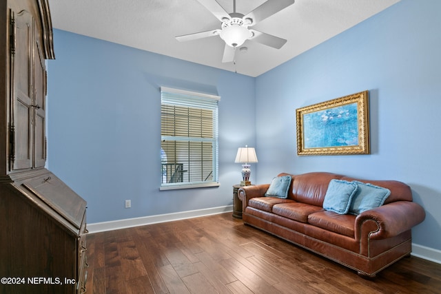 living room with dark hardwood / wood-style flooring and ceiling fan