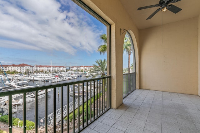 balcony with a water view and ceiling fan