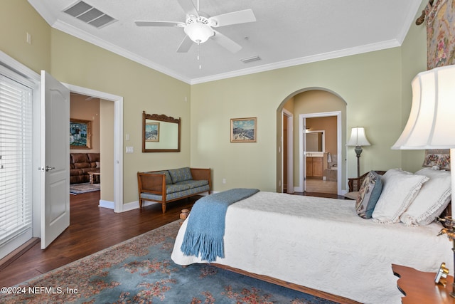 bedroom with ornamental molding, ensuite bath, ceiling fan, and dark hardwood / wood-style floors