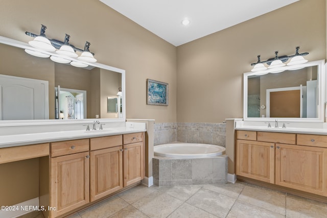 bathroom featuring tiled bath, vanity, and tile patterned floors