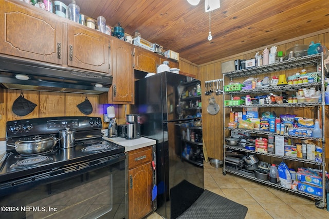 kitchen with black appliances, light tile patterned floors, wooden walls, wooden ceiling, and ceiling fan